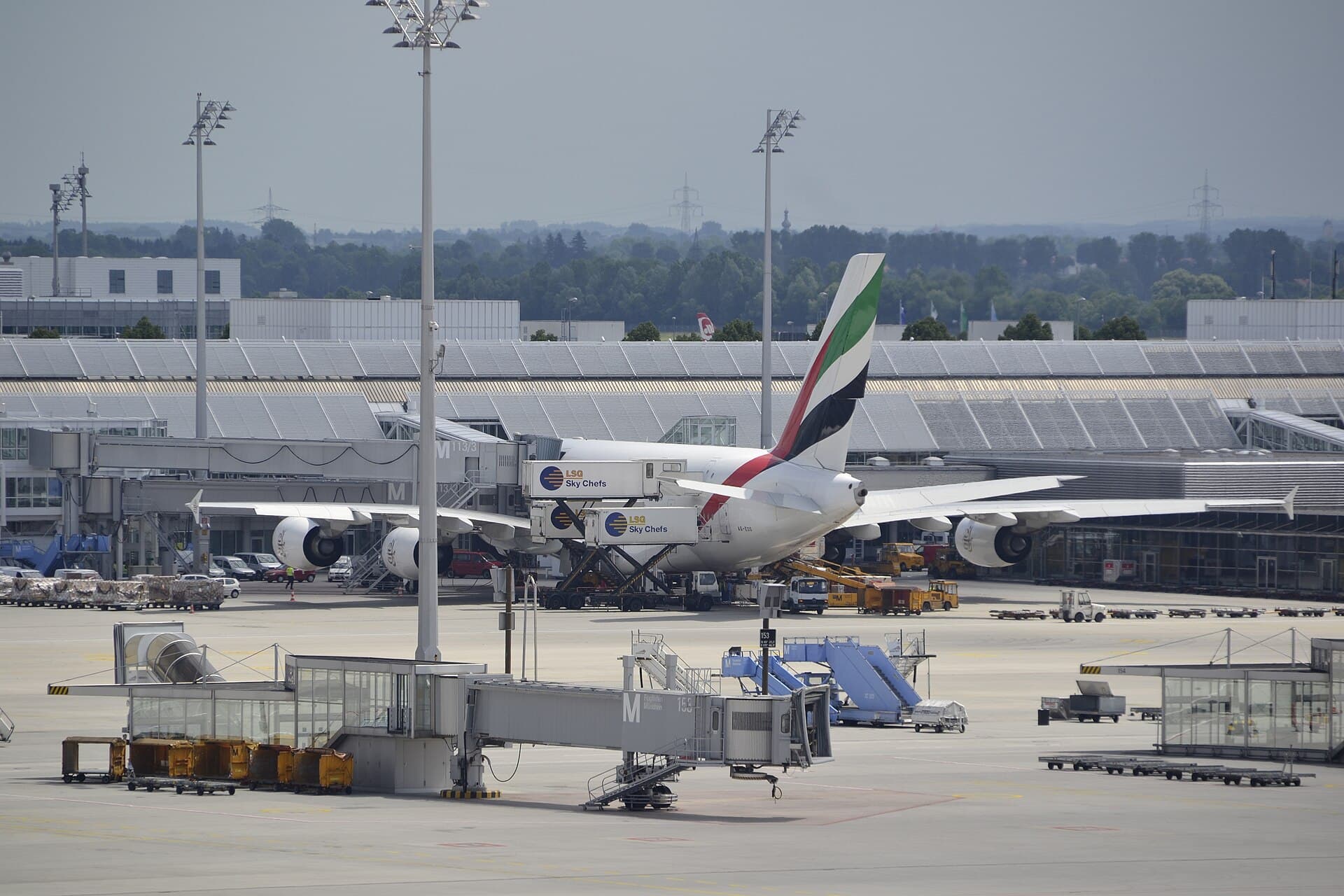 Wide-body airliners parked at gates at Munich Airport on a clear day
