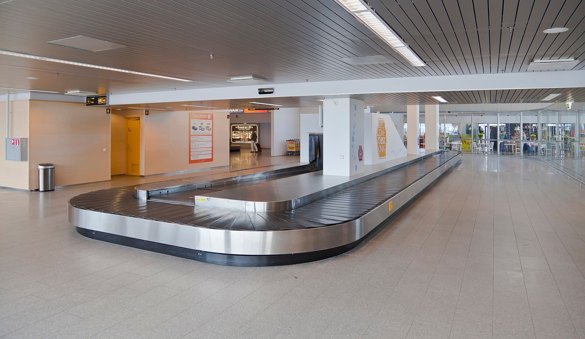 A bright, quiet arrivals hall with a baggage carousel at Tallinn Airport