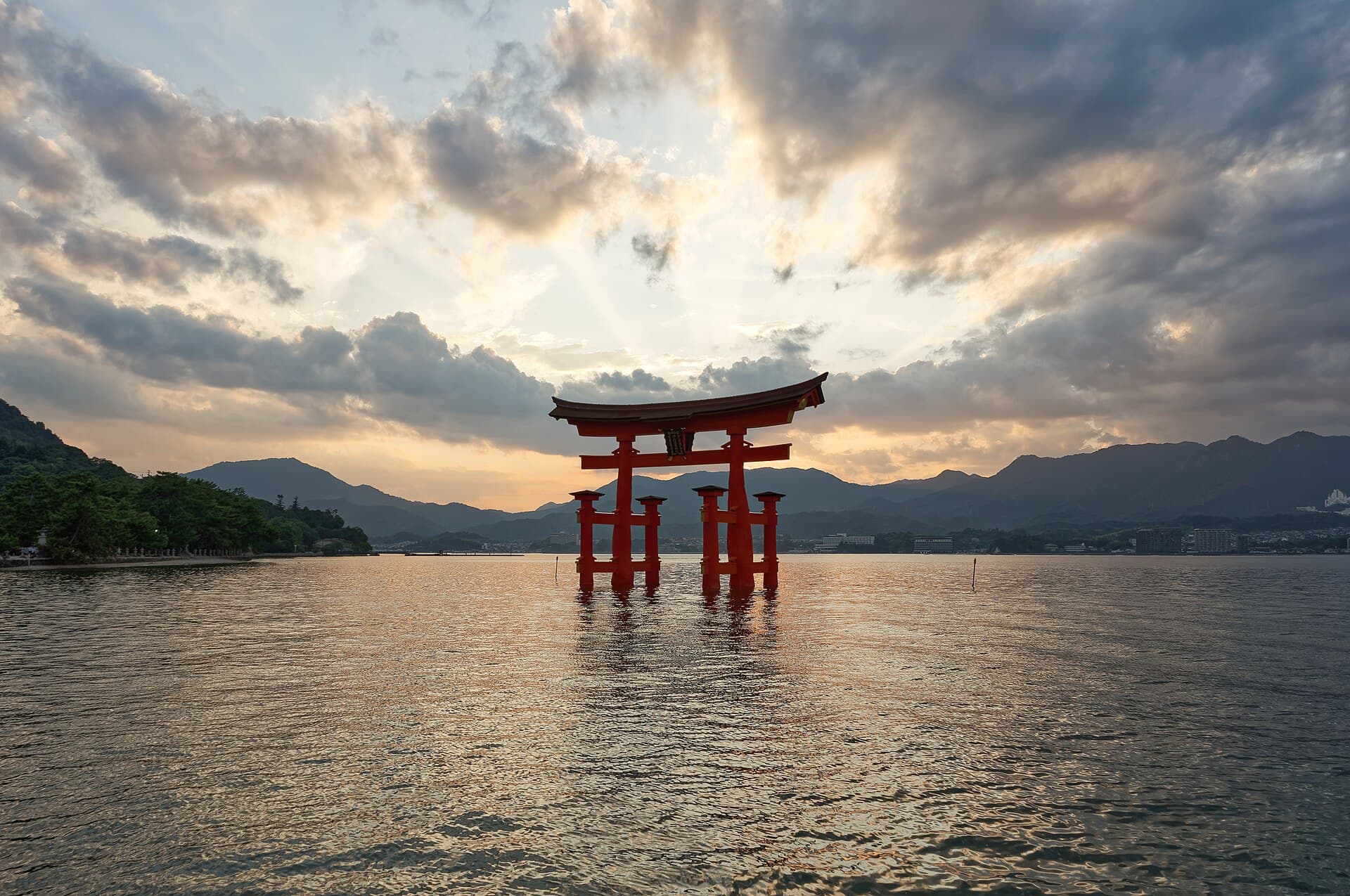 The red floating torii gate of Itsukushima Shrine in the sea at sunset, Miyajima, Japan