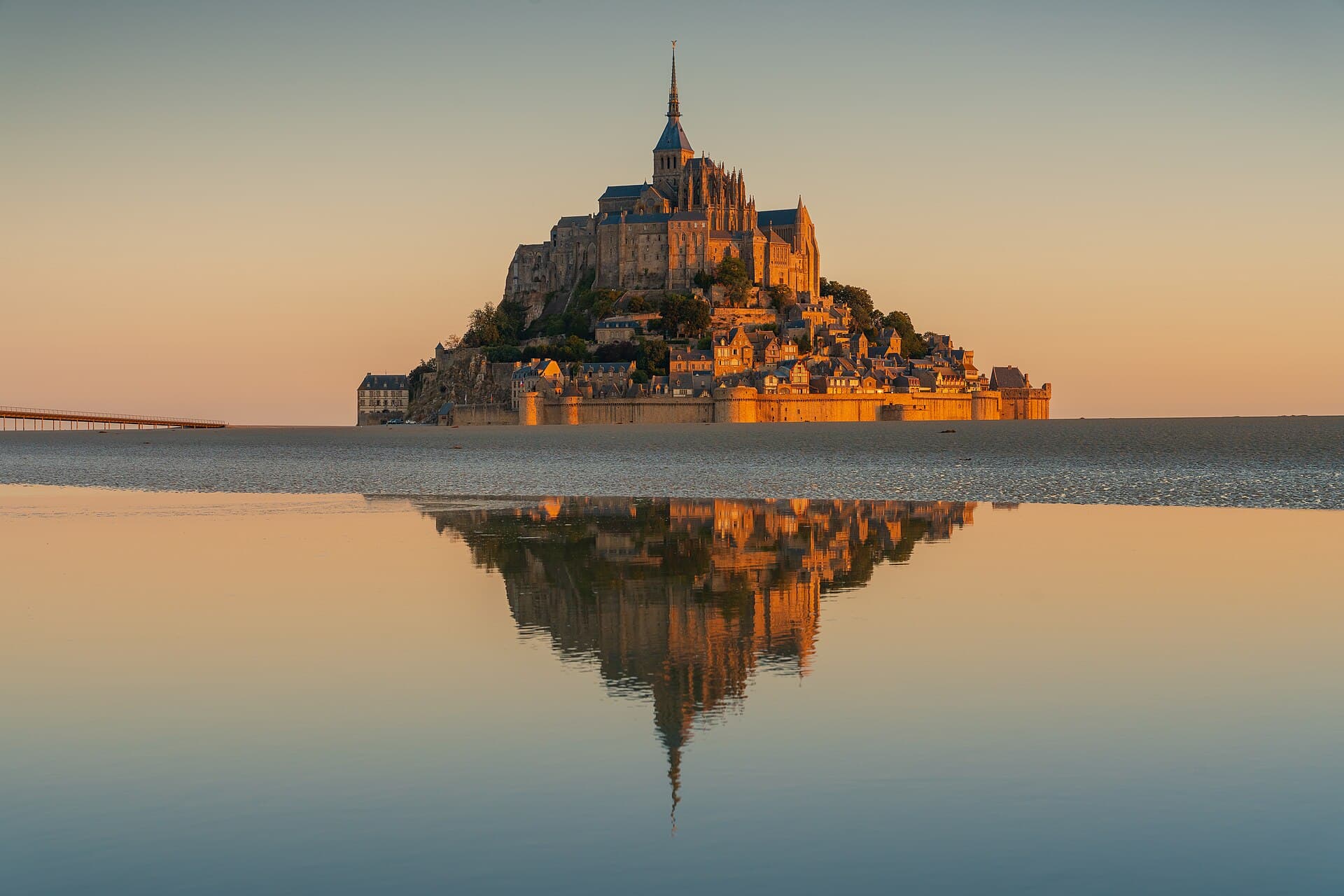 Mont-Saint-Michel at sunrise, reflected in the tidal flats of Normandy
