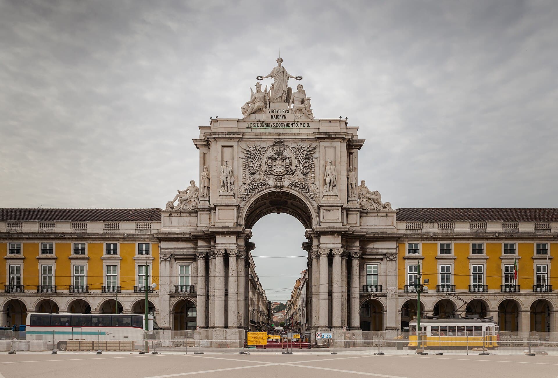 The Rua Augusta Arch on Praça do Comércio, Lisbon, with yellow arcaded buildings