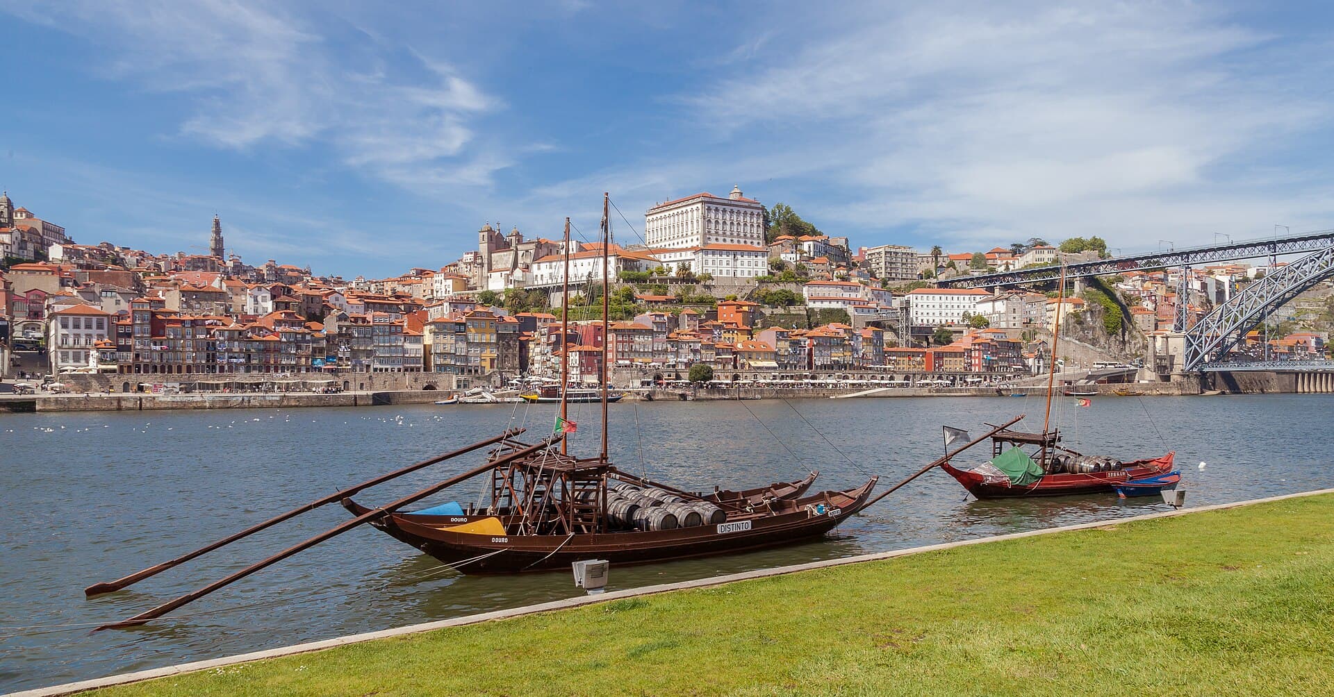 Traditional rabelo boats moored on the Douro river with Porto's hillside old town behind